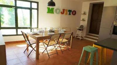 a kitchen with a table and chairs in a room at Maison Les Bruns, sur la route du Mont Ventoux in Bédoin