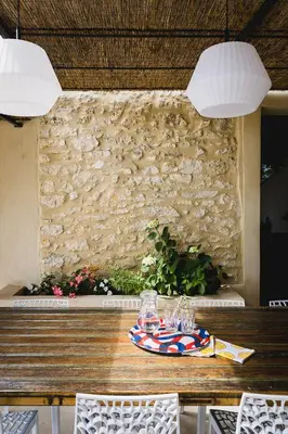 a wooden table with a plate of food on it at Le mas des cerisiers - piscine chauffée in Caumont-sur-Durance