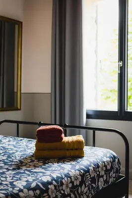a pile of towels sitting on top of a bed at Le mas des cerisiers - piscine chauffée in Caumont-sur-Durance