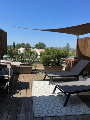 a patio with two lounge chairs and a table at Studios Nuitée en Provence in Aix-en-Provence