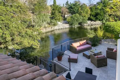 a view of a river from a balcony of a house at Les terrasses di Matt et eaux in LʼIsle-sur-la-Sorgue