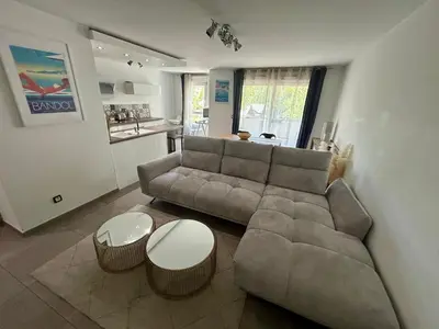 a living room with a couch and two tables at Modern City Center apartment with parking! in Aix-en-Provence