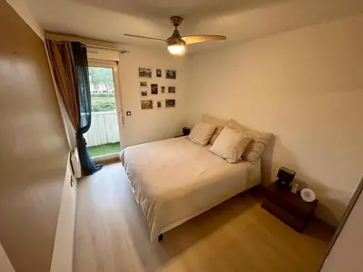 a small bedroom with a bed and a window at Modern City Center apartment with parking! in Aix-en-Provence