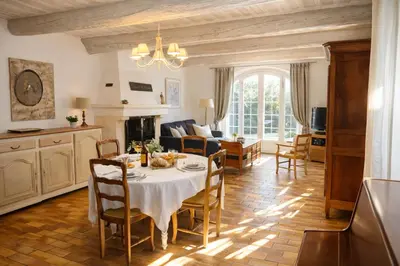 a kitchen and living room with a table and chairs at Mas Caumontois Provençal charm & private pool in Caumont-sur-Durance
