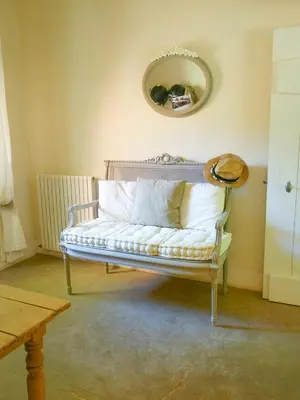 a white couch with pillows on it in a room at Provençal House With Pool Near Roussillon in Roussillon