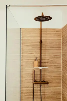 a room with a shower with a table with a lamp at Provençal Villa At Domaine in Cornillon-Confoux