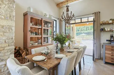 a dining room with a wooden table and chairs at Five-Bedroom Estate Above Ménerbes Village in Ménerbes