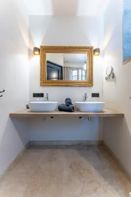 a bathroom with two sinks and a mirror at Five-Bedroom Estate Above Ménerbes Village in Ménerbes