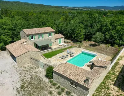 an aerial view of a house with a swimming pool at Family Stone House In Gordes in Gordes