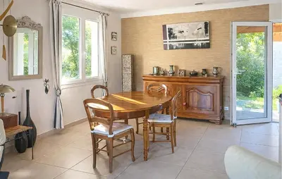 a dining room with a wooden table and chairs at Pet Friendly Home In Caromb in Caromb