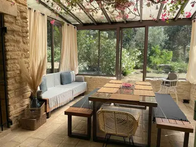 a living room with a couch and a table at L'ISLE SUR LA SORGUE - Maison de prestige in Saumane-de-Vaucluse