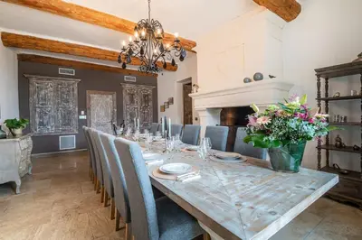 a dining room with a long table and chairs at Wine Estate With Sunset Courtyard Near Bédoin in Mazan
