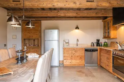 a kitchen with a white refrigerator and wooden cabinets at Wine Estate With Sunset Courtyard Near Bédoin in Mazan