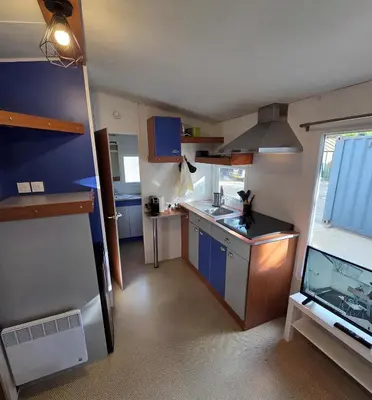a small kitchen with a sink and a stove at Mobile Home Pro - 4 personnes et parking in Pélissanne