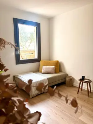 a small room with a couch and a window at Maison bord de rivière - Le Thor in Le Thor