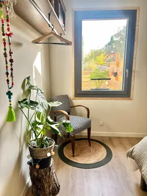 a living room with a chair and a window at Maison bord de rivière - Le Thor in Le Thor