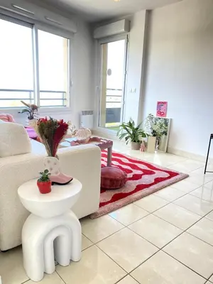 a living room with a couch and a table at Happy appartement in Aix-en-Provence