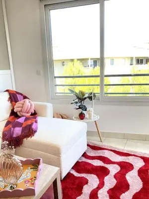 a living room with a couch and a large window at Happy appartement in Aix-en-Provence