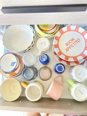 a drawer filled with plates and other dishes at Happy appartement in Aix-en-Provence