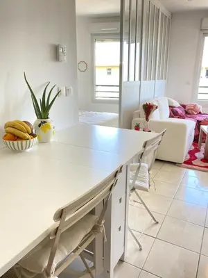 a kitchen with a white counter and a table at Happy appartement in Aix-en-Provence