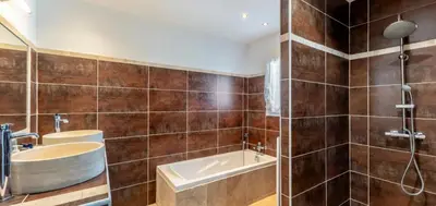 a bathroom with a tub and a sink and a shower at Villa Peyriere-Ventoux in Carpentras