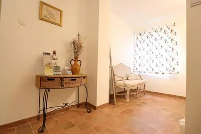 a room with a table and a chair and a window at Gîte Le Relais à Mazan in Mazan
