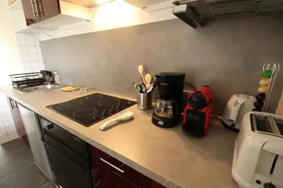 a kitchen counter top with a stove top oven at Gîte Le Relais à Mazan in Mazan