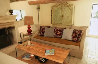 a living room with a couch and a table at 19Th-Century Mas With Pool And Garden Facing Luberon in Oppède