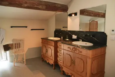 a bathroom with two sinks and a large mirror at 19Th-Century Mas With Pool And Garden Facing Luberon in Oppède