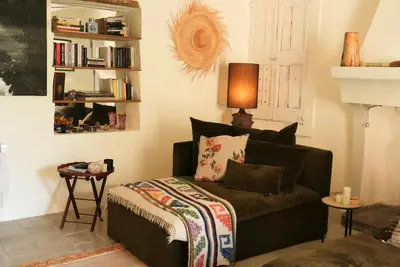 a living room with a couch and a book shelf at 19Th-Century Mas With Pool And Garden Facing Luberon in Oppède