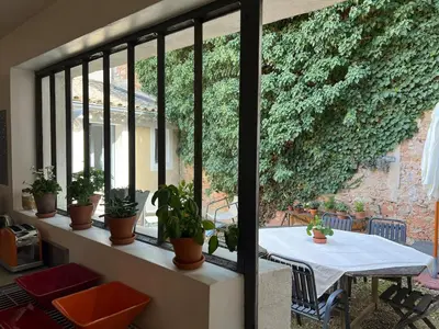 a room with a table and potted plants at Charmante maison de village avec cour intérieure in Bédoin