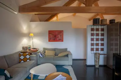 a living room with a couch and a table at La Maison des Restanques in Cabrières-dʼAvignon