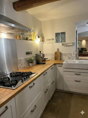 a white kitchen with a stove and a sink at Maison de ville climatisée avec toit-terrasse privatif in Monteux