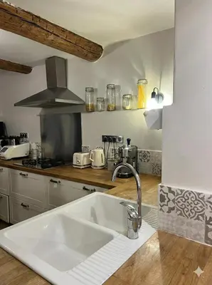a kitchen with a sink and a counter top at Maison de ville climatisée avec toit-terrasse privatif in Monteux