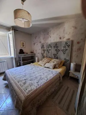 a bedroom with a large bed in a room at Rooms with sculptor in Pinèdes in Aurons