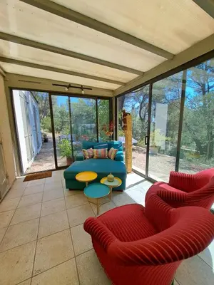 a living room with a couch and a table at Rooms with sculptor in Pinèdes in Aurons