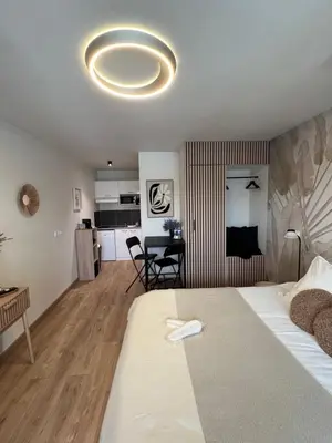 a bedroom with a bed with two pillows on it at Luméa 126 in Éguilles