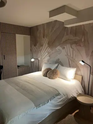 a bedroom with a bed with a teddy bear on it at Luméa 126 in Éguilles