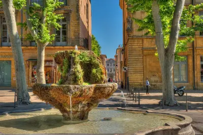 a group of buildings in a city with a tree at Luméa 126 in Éguilles