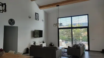 a living room with two couches and a large window at Villa la grande Bastide in Oppède