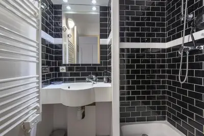 a bathroom with a sink and a mirror and a tub at Village Pont Royal en Provence - maeva Home - Appartement climatisé 4 pièces 6 personnes - Sélection - super Home MAE-7473 in Mallemort