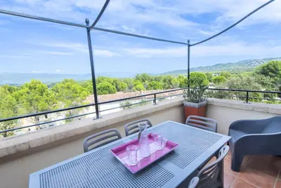 a table and chairs on a balcony with a view at Village Pont Royal en Provence - maeva Home - Appartement climatisé 4 pièces 6 personnes - Sélection - super Home MAE-7473 in Mallemort