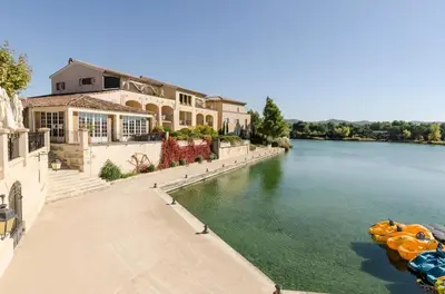 a house on the side of a river at Village Pont Royal en Provence - maeva Home - Appartement climatisé 4 pièces 6 personnes - Sélection - super Home MAE-7473 in Mallemort