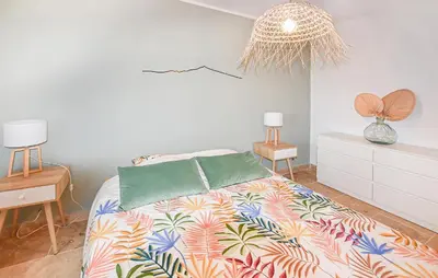 a bedroom with a bed with a colorful bedspread at Maison Avec Piscine Privée in Mazan