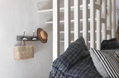 a bed with a pillow and a hat on a wall at Artist's House In The Heart Of Lourmarin in Lourmarin