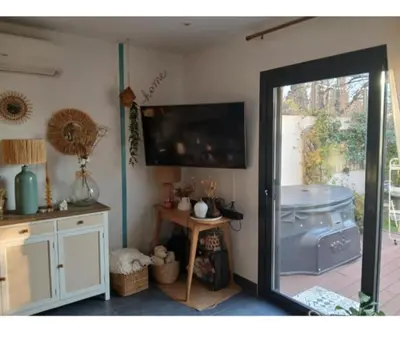 a room with a sliding glass door leading to a patio at Maison climatisée avec jaccuzi in Eyguières
