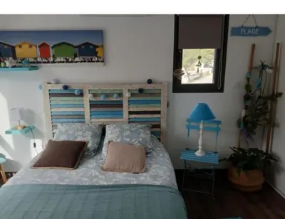 a bedroom with a bed with two pillows on it at Maison climatisée avec jaccuzi in Eyguières