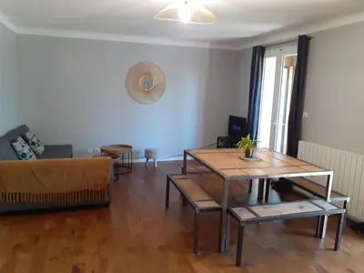 a living room with a table and a couch at Gîte de la Transhumance - 80m2 in Rognes