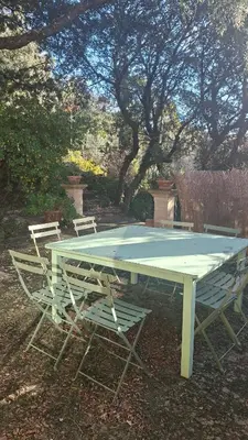 a ping pong table with two chairs around it at Gîte de la Transhumance - 80m2 in Rognes
