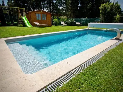 a swimming pool in a yard with a slide at Apartment Gîte Moulin de Tartay by Interhome in Avignon